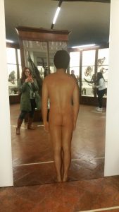 Naked man on a mirror in the monkey room
